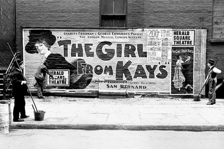 Billposters beside a fresh theatre poster, 1904.